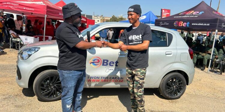 eBet CEO Bonginkhosi Lukhele hands over the Suzuki Celerio to winner Thubelihle Sibandze.