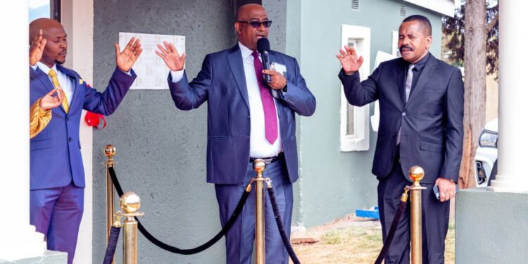 Central Bank Governor Pastor Phil Mnisi and Apostle Trevor Shezi lead prayers outside the newly opened Holyghost Palace Ministries International.