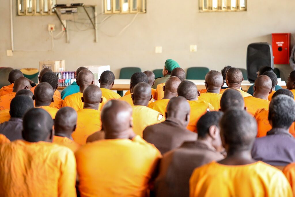 Inmates at Mbabane Correctional Centre listen attentively during the handover ceremony by the Church of the Nazarene.