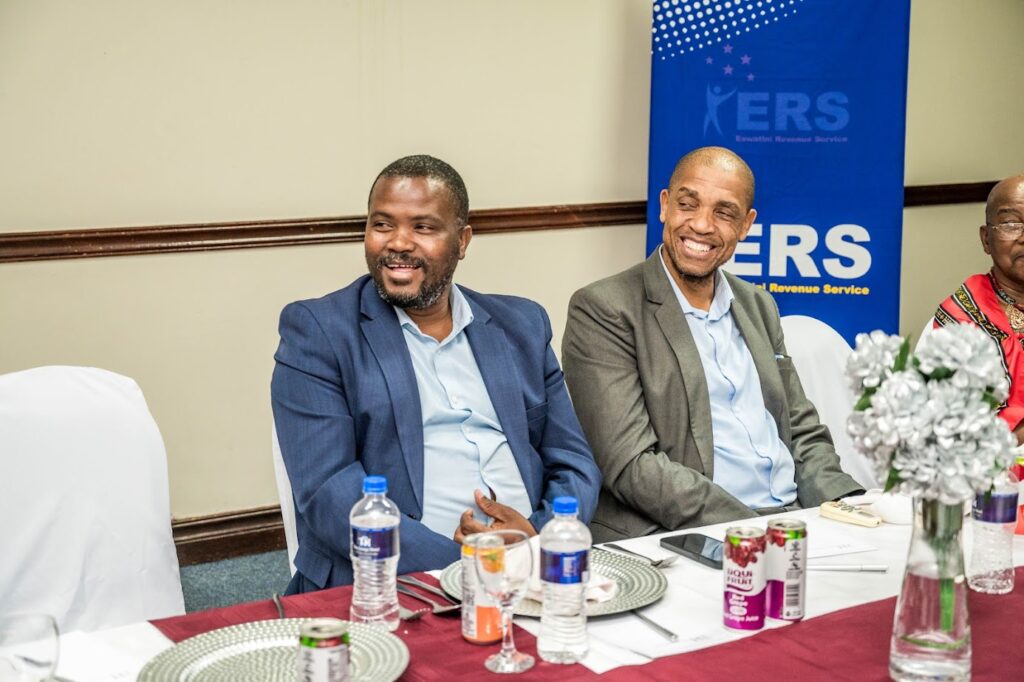 Brightwell Nkambule with Minister of Tinkhundla Sikhumbuzo Dlamini at the follow-up meeting on community business engagement. Photo by ERS.