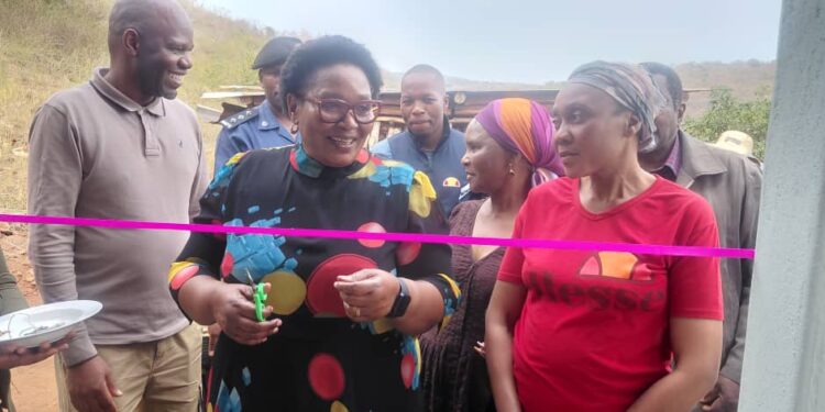 Deputy Prime Minister Senator Thulisile Dladla cuts the ribbon during the official handover of new houses to storm-hit families in Lomahasha.