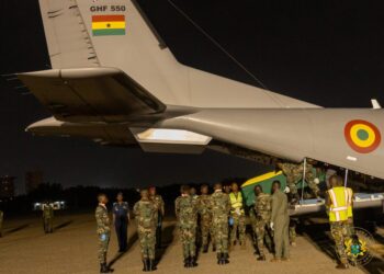 Government and military officials receive the remains of victims from the Adansi helicopter crash at the Air Force Base in Accra on Wednesday night.