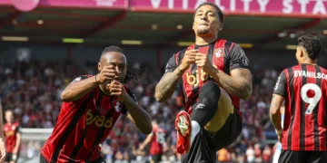 Bournemouth players celebrate Tavernier’s early goal that secured victory over 10-man Wolves.