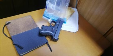 Police display evidence, including a 6mm firearm and torn cash, during the ATM bombing trial.