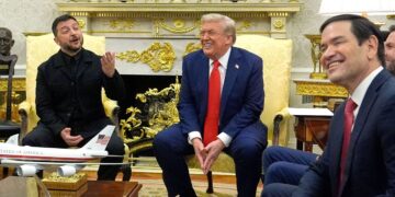 President Donald Trump laughs during a meeting with Ukraine's President Volodymyr Zelensky. Julia Demaree Nikhinson/AP