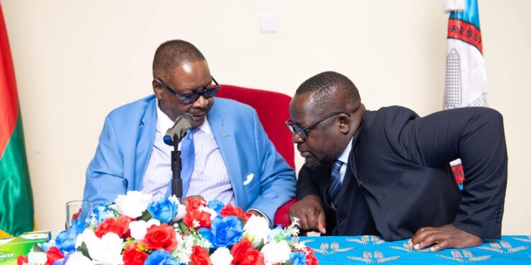 DPP spokesperson Shadric Namalomba with party leader Peter Mutharika during a campaign event