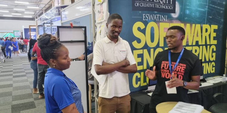 Lucky Mathonsi, Communications Manager, engaging visitors and answering enquiries at the Limkokwing University of Creative Technology stall during the Eswatini International Trade Fair at Mavuso.