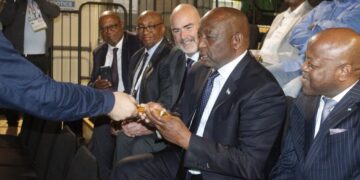 Lesotho Prime Minister Ntsokoane Matekane inspects a gold bar during his tour of The Perth Mint in Australia.
