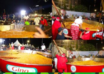 Chef Hilda Baci stirs the giant pot of jollof rice during her record attempt at the Eko Hotel and Suites in Lagos