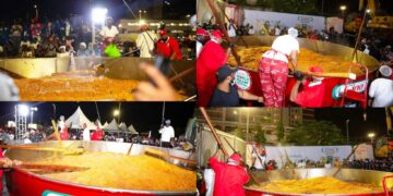 Chef Hilda Baci stirs the giant pot of jollof rice during her record attempt at the Eko Hotel and Suites in Lagos