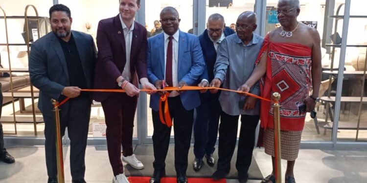 Minister of Commerce, Industry and Trade Manqoba Khumalo, the US Embassy Chargé d’Affaires, and other dignitaries cut the ribbon during the official opening of Ashley Eswatini at the Lifestyle Centre in Matsapha.