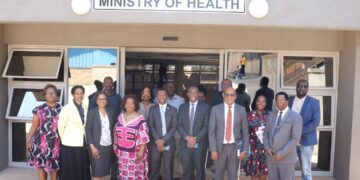 Acting Minister Appolo Maphalala poses with Biomedical and HMIS unit staff at the handover ceremony of the newly constructed offices at the former CMS complex.