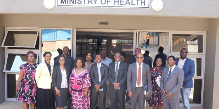 Acting Minister Appolo Maphalala poses with Biomedical and HMIS unit staff at the handover ceremony of the newly constructed offices at the former CMS complex.