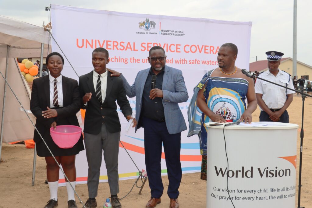 World Vision Eswatini National Director Amos Zaindi and Minister of Tinkhundla Development and Administration Skhumbuzo Dlamini pictured with two students during the Ekukhanyeni development handover ceremony