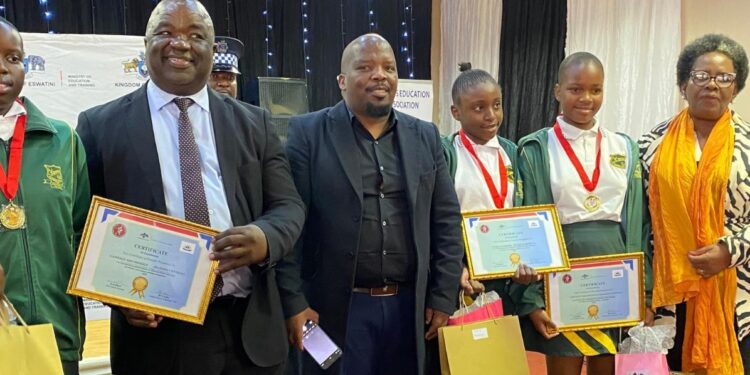Minister of Education and Training Owen Nxumalo pictured with some of the learners who received awards during the national essay writing competition ceremony in Mbabane.