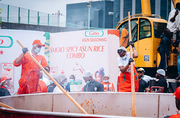 Hilda Baci stirring the record-breaking 8,780 kg jollof rice at Victoria Island event