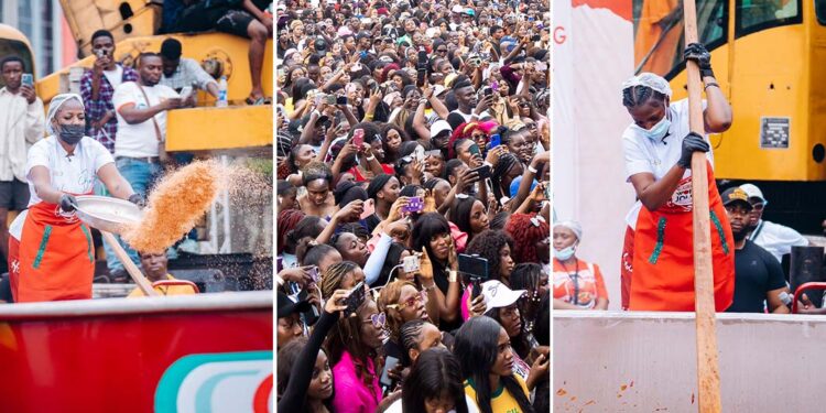 Hilda Baci stirring the record-breaking 8,780 kg jollof rice at Victoria Island event