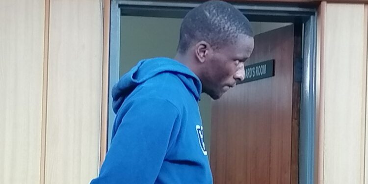 The 24-year-old stands in the dock, his face betraying a mix of remorse and resignation as the sentence is read out.