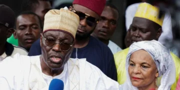 Opposition Presidential candidate Issa Tchiroma Bakary of the National Salvation Front (FSNC) speaks to the media after casting his vote. / Reuters