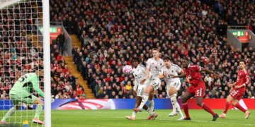 Harry Maguire watches intently as his header finds the back of the net, giving Manchester United the lead at Anfield.