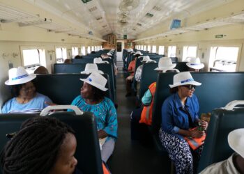 Passengers on board the train to Maputo pause at Mlawula Train Station, December 7, 2018.