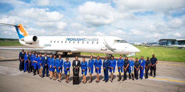 Proflight Zambia flight attendants pose beside one of the airline’s aircraft at Kenneth Kaunda International Airport ahead of the 55th AASA Annual General Assembly in Lusaka