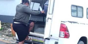 Simphiwe Maziya, 33, enters a police vehicle after being sentenced for Shoprite liquor theft in Mbabane.
