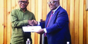 Ras Mubarak, leader of the Trans African Tourism and Unity Campaign, with Zimbabwe’s Permanent Secretary in the Ministry of Home Affairs and Cultural Heritage, Ambassador Raphael Tayerera Faranisi, during a meeting in Harare on Monday.