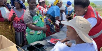 Women receive cash assistance from the Eswatini Red Cross to support their families at Mfasini royal kraal.