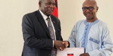 Malawian Foreign Affairs Minister George Chaponda receives the Memorandum of Understanding from Trans-Africa Tourism and Unity Campaign leader Ras Mubarak at the ministry’s headquarters in Lilongwe.
