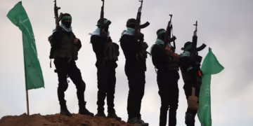 Hamas militants gather in Khan Yunis, on February 20, before the handing over of the bodies of four Israeli hostages. Eyad Baba/AFP/Getty Images/File