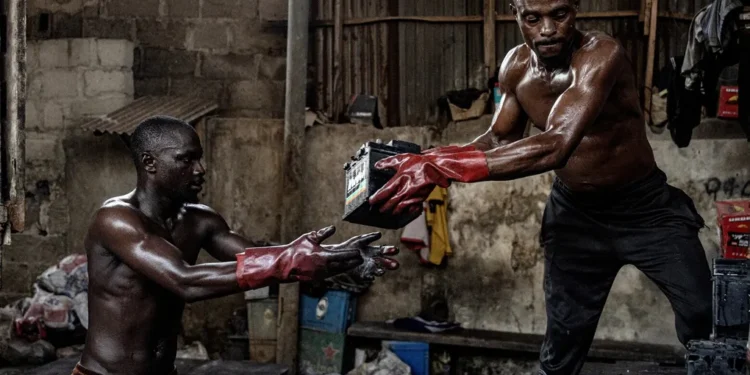 Each night, laborers work in a sort of bucket brigade to load batteries for delivery to the factories.