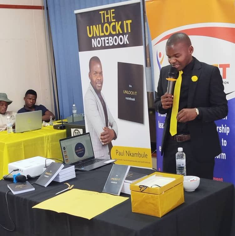 Paul Nkambule unveiling his new book Unlock It Notebook at the official launch event