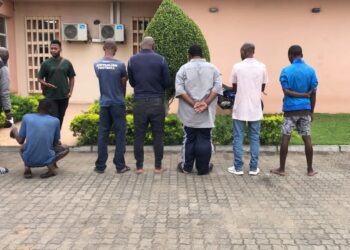 The eight accused face away from the camera while in police custody in Matola. Photo: TV Miramar