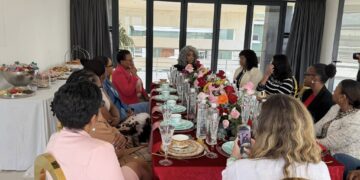 Women leaders engage in conversation during a luncheon hosted by Minister of ICT Hon. Savannah Maziya, sharing insights and experiences over a meal.