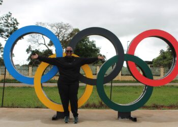 Mrs. Dorothy Tlagae-Gaseitsiwe, CEO of the Botswana National Olympic Committee, poses beside the Olympic rings during her visit to Eswatini.