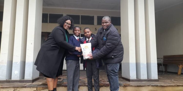 Two students receive seed packages as part of the Green Schools Initiative, supported by the Eswatini Environment Authority. Photo credit: Eswatini National Commission for UNESCO.
