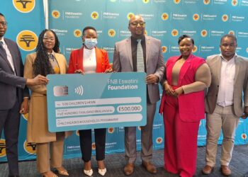 FNB Eswatini CEO Thokozani 'TK' Dlamini presents a E500,000 sponsorship cheque to support SOS Children's Village Child-Headed Households Programme. Photo by FNB Eswatini