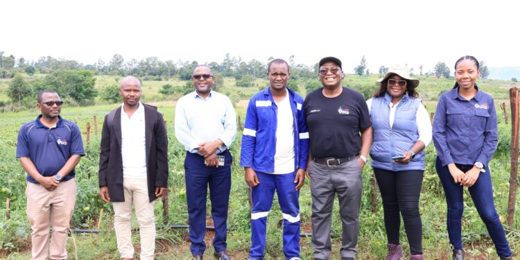 YERF CEO Mandla Nkambule and World Vision National Director Amos Zaindi pose with youth entrepreneurs during field visits under the Enterprise Facilitation Programme. Photo by YEF