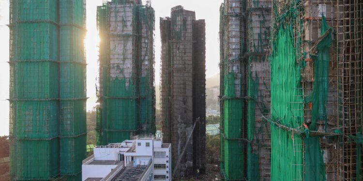 Charred remains of multiple residential towers following a deadly fire on Wednesday at Wang Fuk Court housing complex, in Tai Po, Hong Kong, China, November 29, 2025. REUTERS/Tyrone Siu