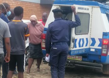 The mother being assisted into a police van. (Pic, Sithembiso Sihlongonyane)