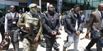 A heavy security team around the Ndimande brothers leaving the King Shaka International Airport in shackles. They were rushed to the Durban Central police station, before their scheduled court appearance. (Pic: Doctor Ngcobo/Independent Media)