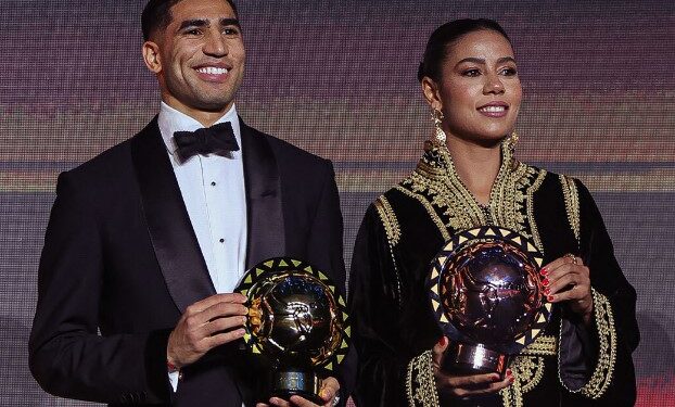 Achraf Hakimi and Ghizlaine Chebbak pose together after winning the CAF Player of the Year awards. Photo by CAF