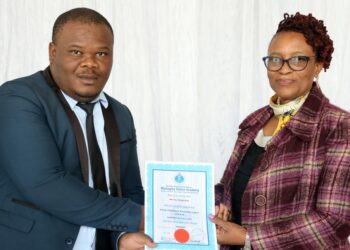 Deputy National Commissioner Ms. Mumsy Dlamini presents a certificate to one of the newly graduated police officers after completing the Basic Criminal Investigation Department Course at the Matsapha Police Academy. Photo credit: Royal Eswatini Police Service