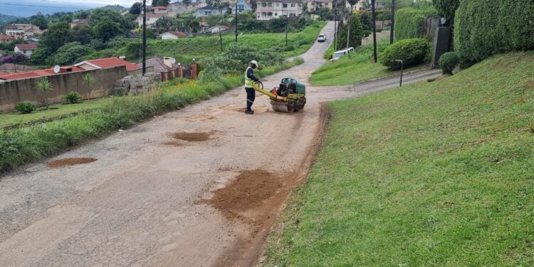 A worker filling potholes on Lukhozi Street in Thembelihle, Mbabane, during recent repairs. Photo by Adekunle Owolabi.