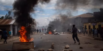 People protest in the streets of Arusha, Tanzania during the election day on October 29, 2025. Stringer/AP
