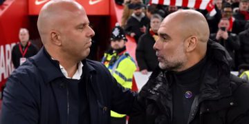 Arne Slot embraces Pep Guardiola at Anfield (Liverpool FC via Getty Images)
