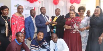 Minister S’khumbuzo Dlamini and NERCHA representatives join community members during the candle lighting ceremony to mark World AIDS Day in Mbabane.