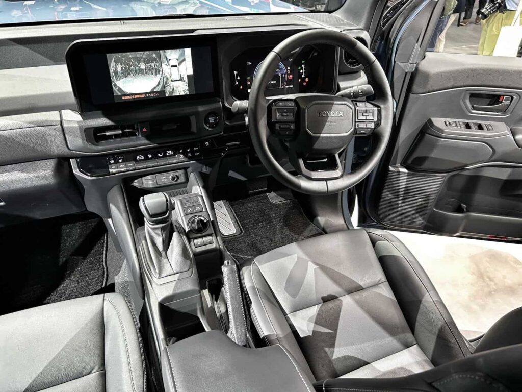 Interior of the Land Cruiser FJ featuring a modern dashboard with dual digital displays and manual drive selectors. (Picture: Jaco van der Merwe)