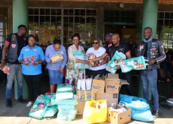 Members of the Hyena Motorcycle Club and other biker groups pose with His Majesty’s Correctional Services officials during a donation handover at the Mawelawela Women’s Correctional Centre